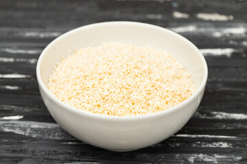 Coconut flakes in white small bowl