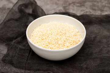 Coconut flakes in white small bowl