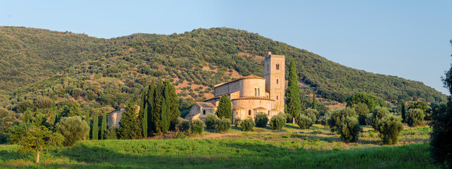 Montalcino, Tuscany: panorama of the ancient abbey of Sant'Antimo. View banners. - 640759232