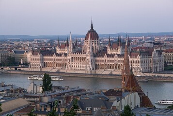 Fototapeta na wymiar Budapest, Hungary - Aug 19, 2023: View of the Budapest city from the Kilatopont viewpoint in a sunny summer day. Budapest Parliament. Selective focus.