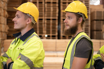 Group of workers in a large timber factory, Have fun by raising your arms after completing the...
