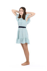 Young beautiful girl in a dress with polka dots on a white background.