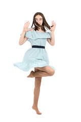 Young beautiful girl in a dress with polka dots on a white background.