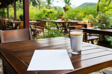 Blank note paper on wood table at the cafe . High quality photo