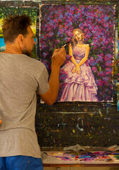 Artist in the studio painting an oil painting of a girl in purple lilac flowers