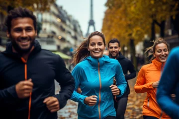 Foto auf Acrylglas Group people in color sportswear, women's and men's running at Paris city in splashes rain.  © Andrii IURLOV
