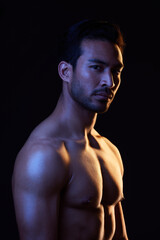 Fototapeta premium Shirtless, portrait and sexy man on black background in fitness inspiration, beauty aesthetic or sensual fantasy. Erotic art, sexual body or seductive male model with muscle, studio and neon lighting