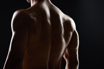 Man, back and muscle with silhouette, studio and shadow for wellness, health and strong by black...
