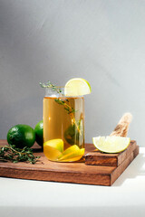 Drink with orange lemon and lime in transparent glasses on a concrete background. Lemonade with...
