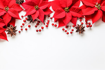 Christmas decoration: Red poinsettia flowers tree branches ball and berries on white background with text space 