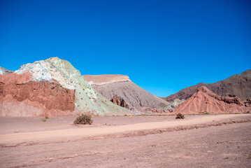 colored rocks against a blue sky at valle arcoiris, antofagasta, atacama, chile