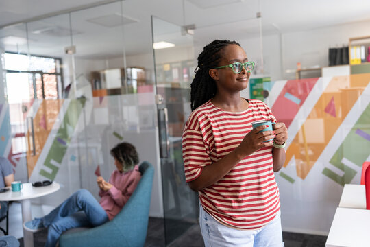 In her college office, a determined black female student sitting confidently, a beacon of empowerment and knowledge, ready to conquer academic challenges and embrace her future. 