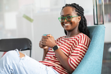 In her college office, a determined black female student stands confidently, a beacon of...