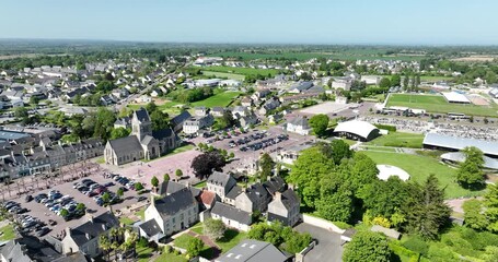 Church and city square of Sainte mere eglise, WW2 landmark, France. Aerial drone view. Air drop landmark.