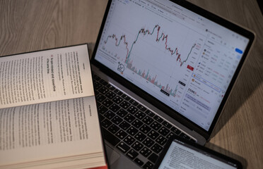 book and financial graph on the desk