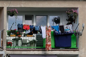 Close-up of a balcony in an apartment block with hanging laundry