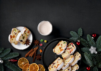 Traditional German Christmas cake , Stollen cutting on the plate with Christmas decoration and spices and a cup of coffee.top view, copy space