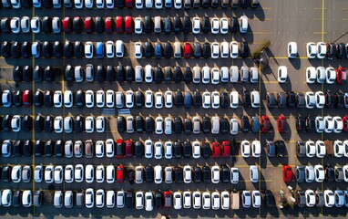 an aerial photo capturing the organized arrangement of brand-new cars lined up at the port, ready for import and export logistics. This scene highlights the efficiency.