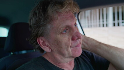 Preoccupied senior man in distress struggles with depression and solitude inside car. Overwhelmed...