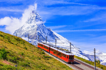 Zermatt, Switzerland. Gornergrat tourist train with Matterhorn mountain in the background. Valais region. - obrazy, fototapety, plakaty