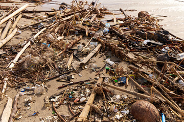 Mountains of waste and garbage on the sandy beach after the tide. Humanity is polluting the ocean