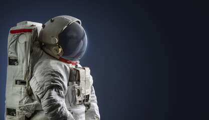 Astronaut in dark space. Spaceman on black background. Elements of this image furnished by NASA
