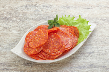 Sliced pepperoni sausage in the bowl