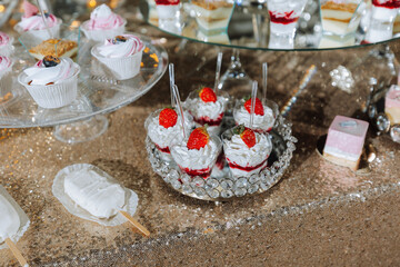 A sweet table at a wedding. Table with cakes and sweets at the festival. Birthday sweets