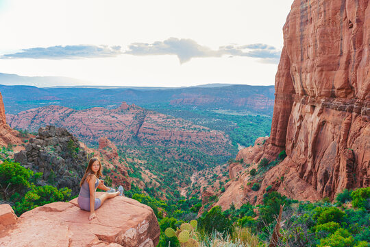 Little girl on the edge of a cliff at Cathedral Rock in Sedona, Arizona. 