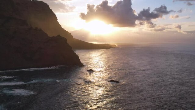 Aerial sunset light over ocean and volcanic cliffs of Tenerife Canary Island Spain