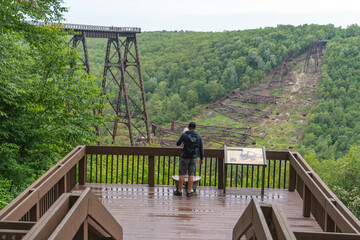 Kinzua state park bridge waving platform walkway tourist attraction, copy space Pennsylvania landmark attraction, natural light, early autumn season, overcast day.