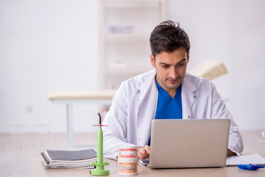 Young male dentist working in the clinic