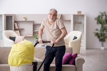 Old man looking after newborn at home