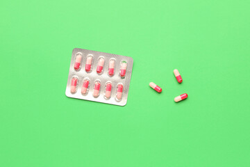 Blister of hormonal pills on green background