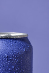 Can of fresh soda with water drops on lilac background, closeup