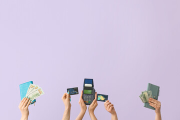Women with money, wallets, credit cards and payment terminal on lilac background