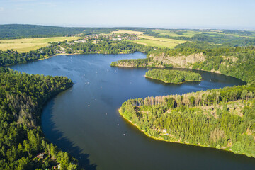 Aerial view of lake Sec with beautiful island. Famous tourist destination in Pardubicky kraj, Czech republic, European union.