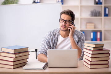 Young male student preparing for exams in the classroom