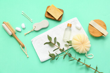 Composition with different bath supplies and eucalyptus branch on color background