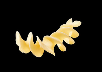 Pasta fusilli noodle isolated on black, close up