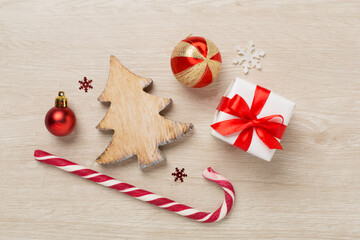 Miniature christmas tree with gift box and decor on wooden background