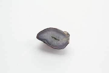 Natural violet amethyst druse geode mineral crystal polished semi-precious gemstone on light...