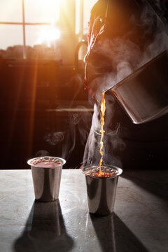 Woman pouring steaming hot health drink for cold 