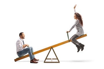 Happy young man and woman playing on a seesaw