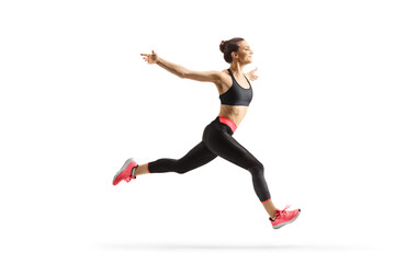 Full length profile shot of a fit young woman running and spreading arms