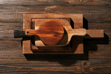Different cutting boards on wooden background