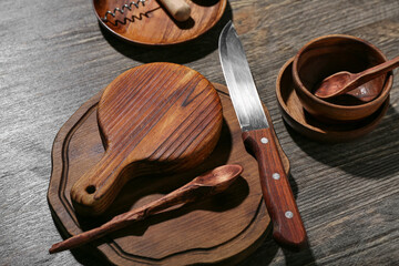 New cutting boards, knife and spoon on wooden background