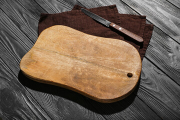 New cutting board and knife on grey wooden background