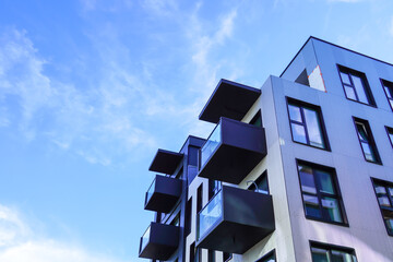 Look up to white appartment building with balconies towards blue sky. Kalamaja, Tallinn, Estonia