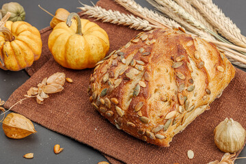 Fresh bread with pumpkin seeds. Home baking concept. Autumn decor